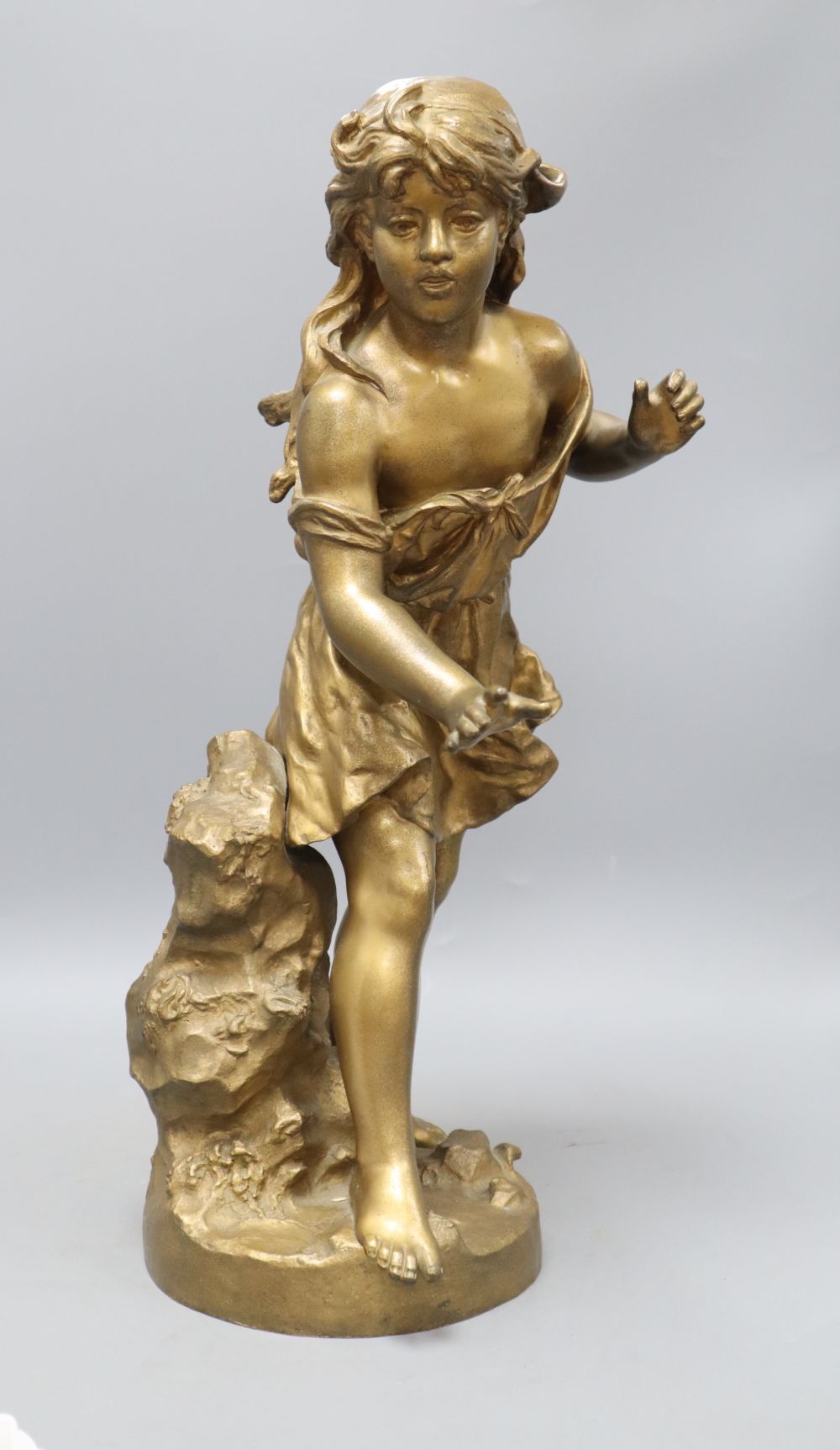 An early 20th century gold painted bronze model of a girl, height 50cm